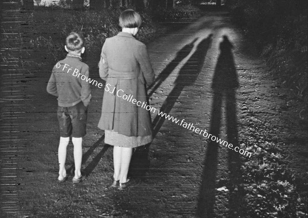 CHILDREN WALKING AND CASTING LONG SHADOWS